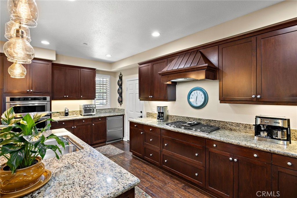 37 Tuscany Ladera Ranch, CA 92694 - Photo 17 of 53 a kitchen with stainless steel appliances granite countertop a stove a sink and a microwave