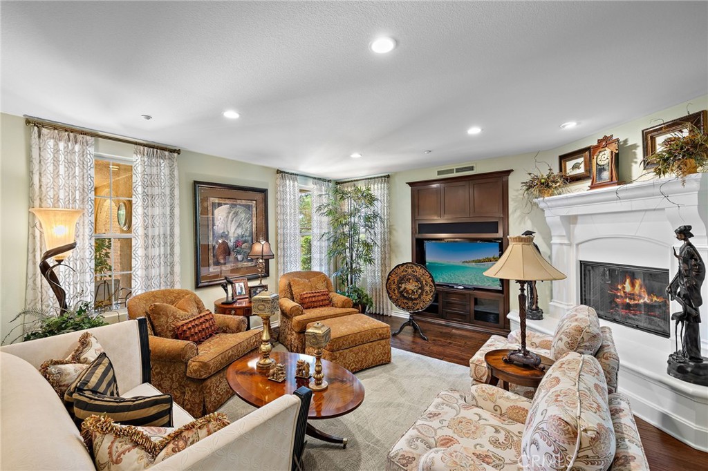 37 Tuscany Ladera Ranch, CA 92694 - Photo 18 of 53 a living room with furniture a fireplace and a flat screen tv