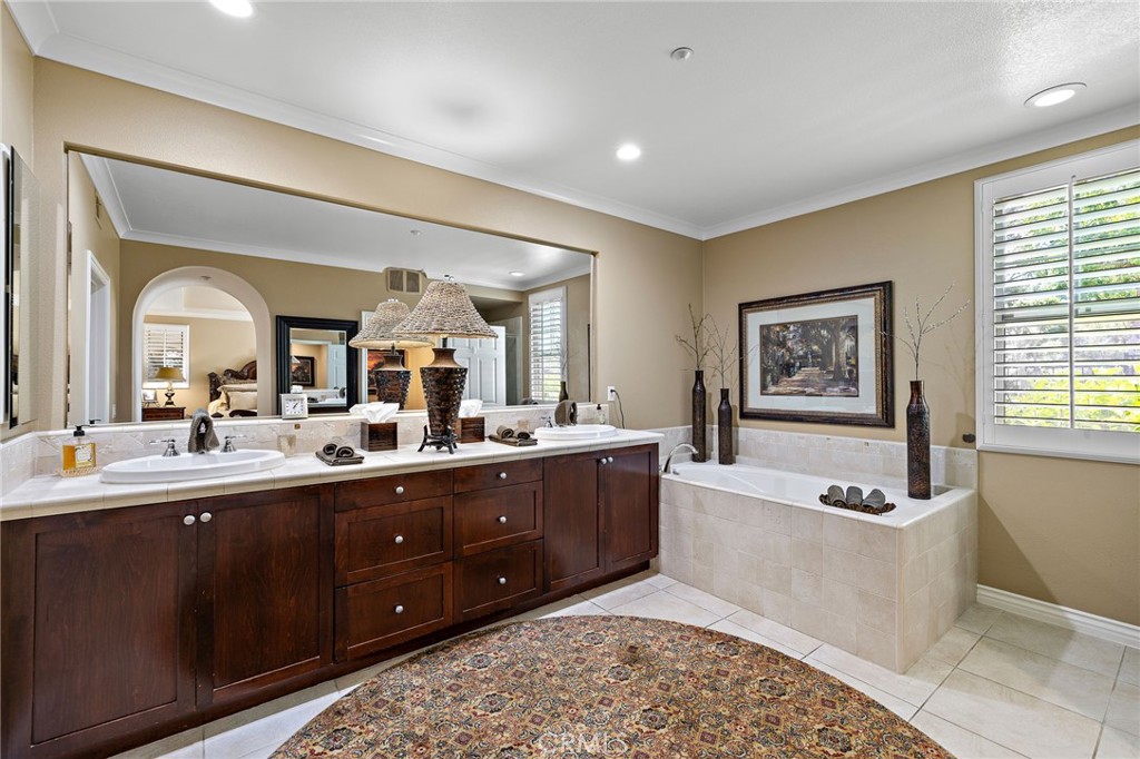 37 Tuscany Ladera Ranch, CA 92694 - Photo 23 of 53 a large bathroom with a tub a double vanity sink a window and a mirror