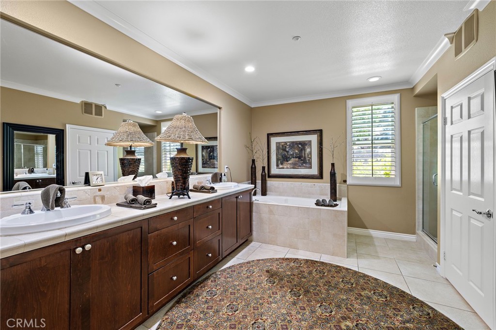 37 Tuscany Ladera Ranch, CA 92694 - Photo 24 of 53 a spacious bathroom with a double vanity sink a mirror and a bathtub