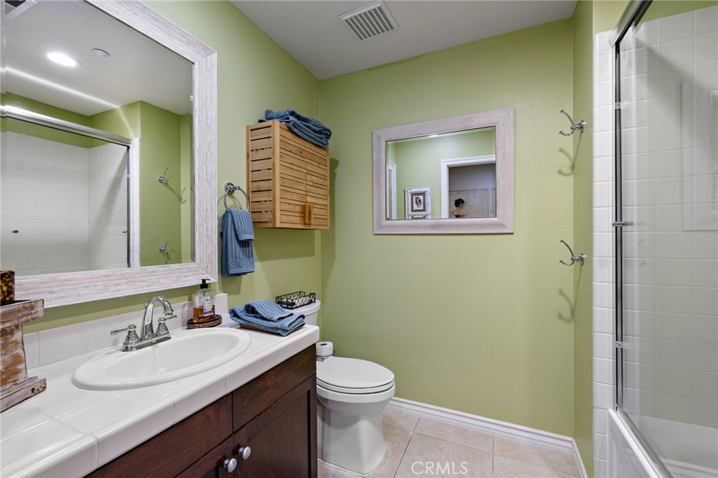 37 Tuscany Ladera Ranch, CA 92694 - Photo 29 of 53 a bathroom with a granite countertop sink toilet and mirror