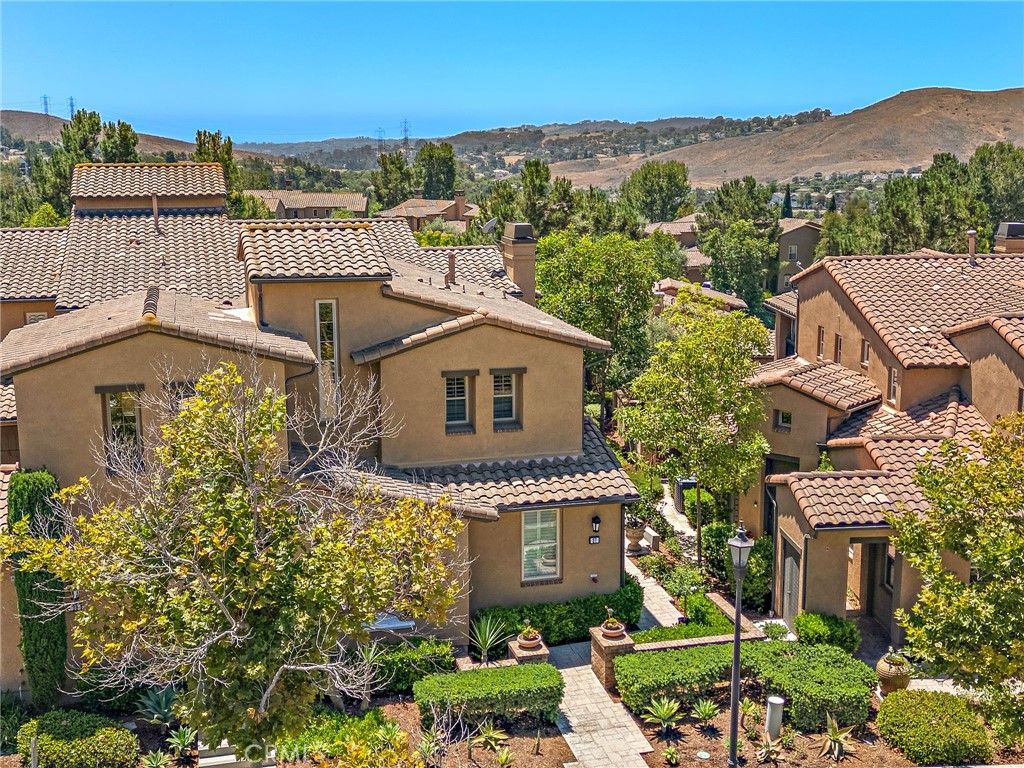 37 Tuscany Ladera Ranch, CA 92694 - Photo 40 of 53 a front view of a house with a yard and mountain view in back
