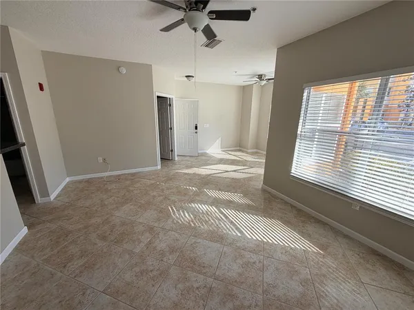 a view of an empty room and a window