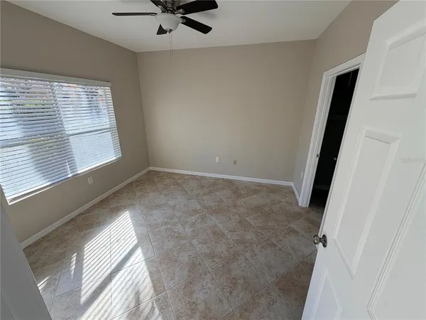a view of an empty room and a window