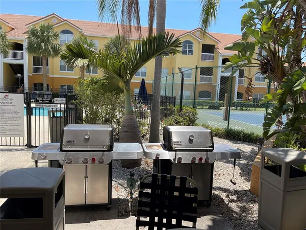 a view of a patio with table and chairs and potted plants