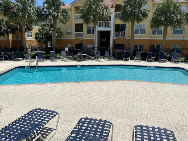a view of a patio with dining table and chairs