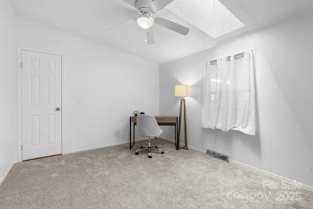 a view of a workspace with furniture