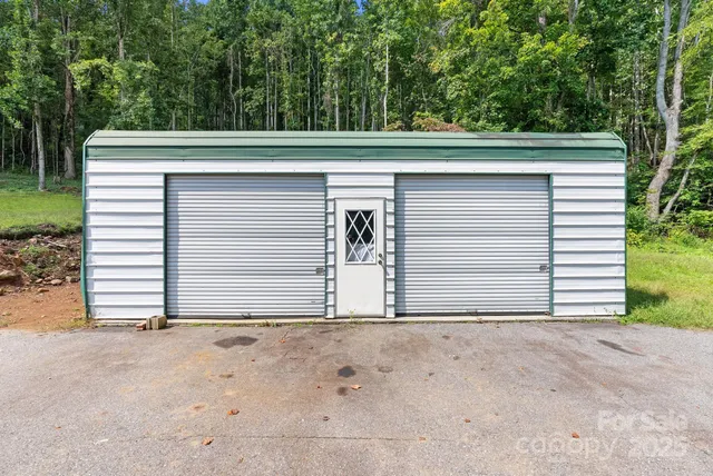 a view of backyard with small cabin