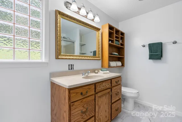a bathroom with a toilet sink and mirror