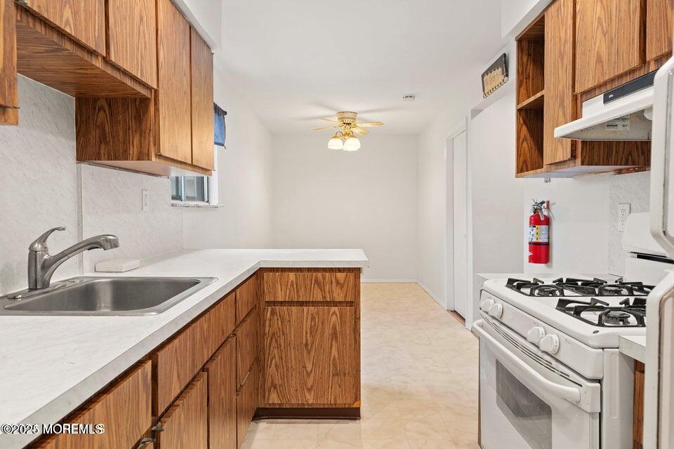 321 Lockheed Road Brick, NJ 08723 - Photo 8 of 16 a kitchen with stainless steel appliances a sink a stove and a refrigerator