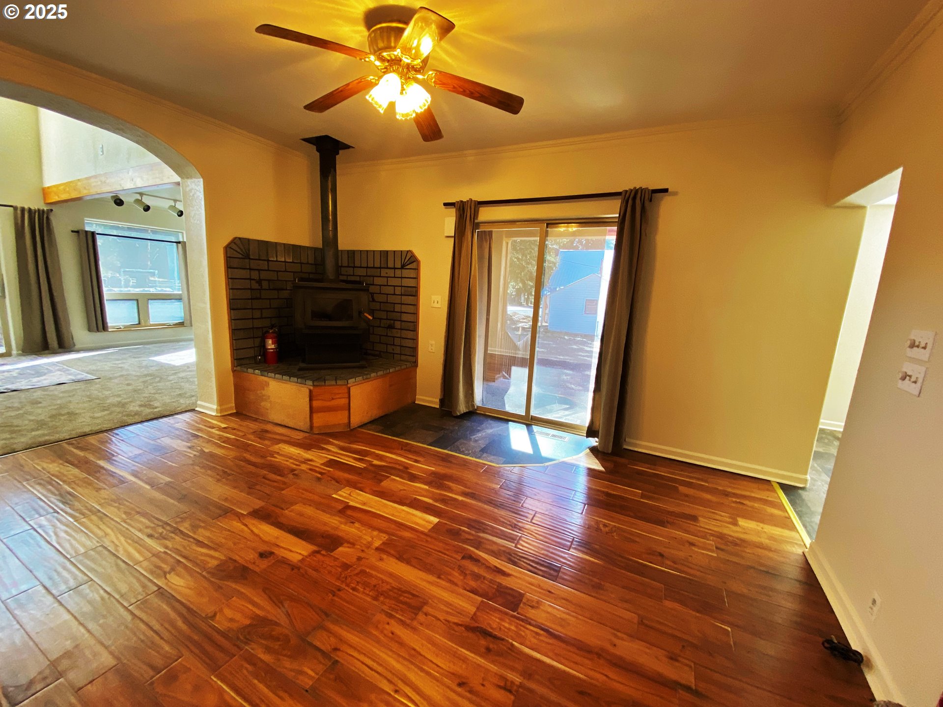 379 Mill Street Sumpter, OR 97877 - Photo 11 of 17 a view of a livingroom with wooden floor and a ceiling fan
