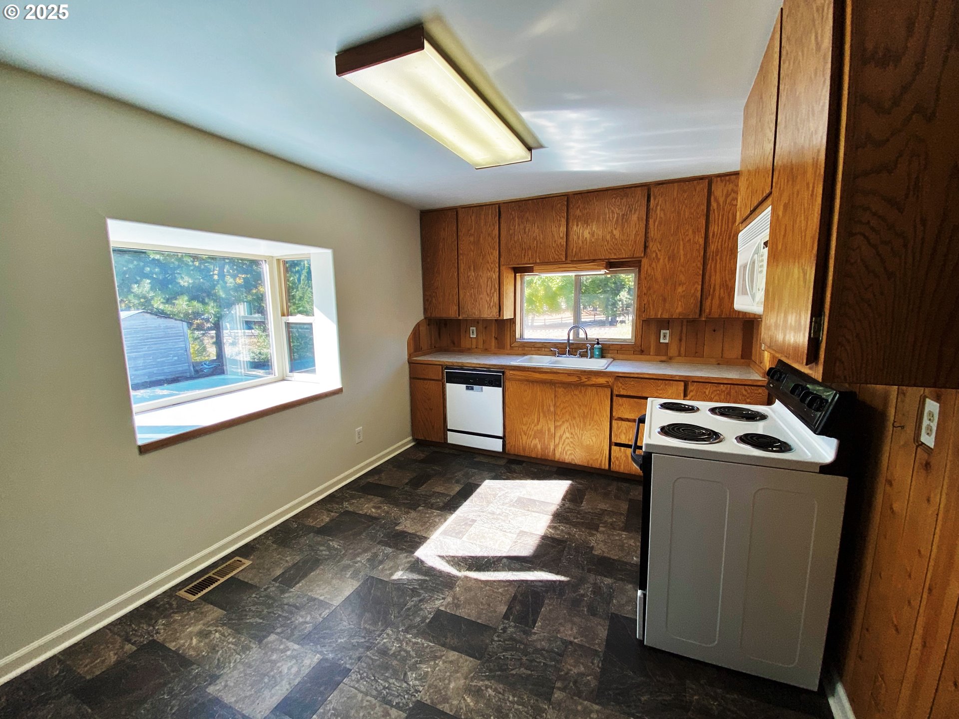 379 Mill Street Sumpter, OR 97877 - Photo 12 of 17 a kitchen with a stove a sink and a refrigerator