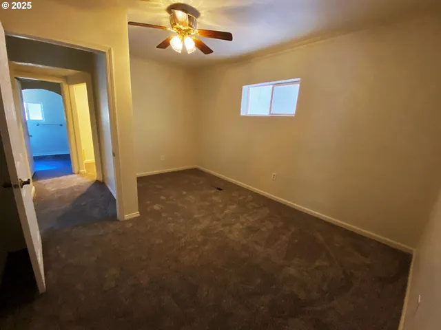 a large spacious bathroom with a granite countertop double vanity sink a mirror and a shower