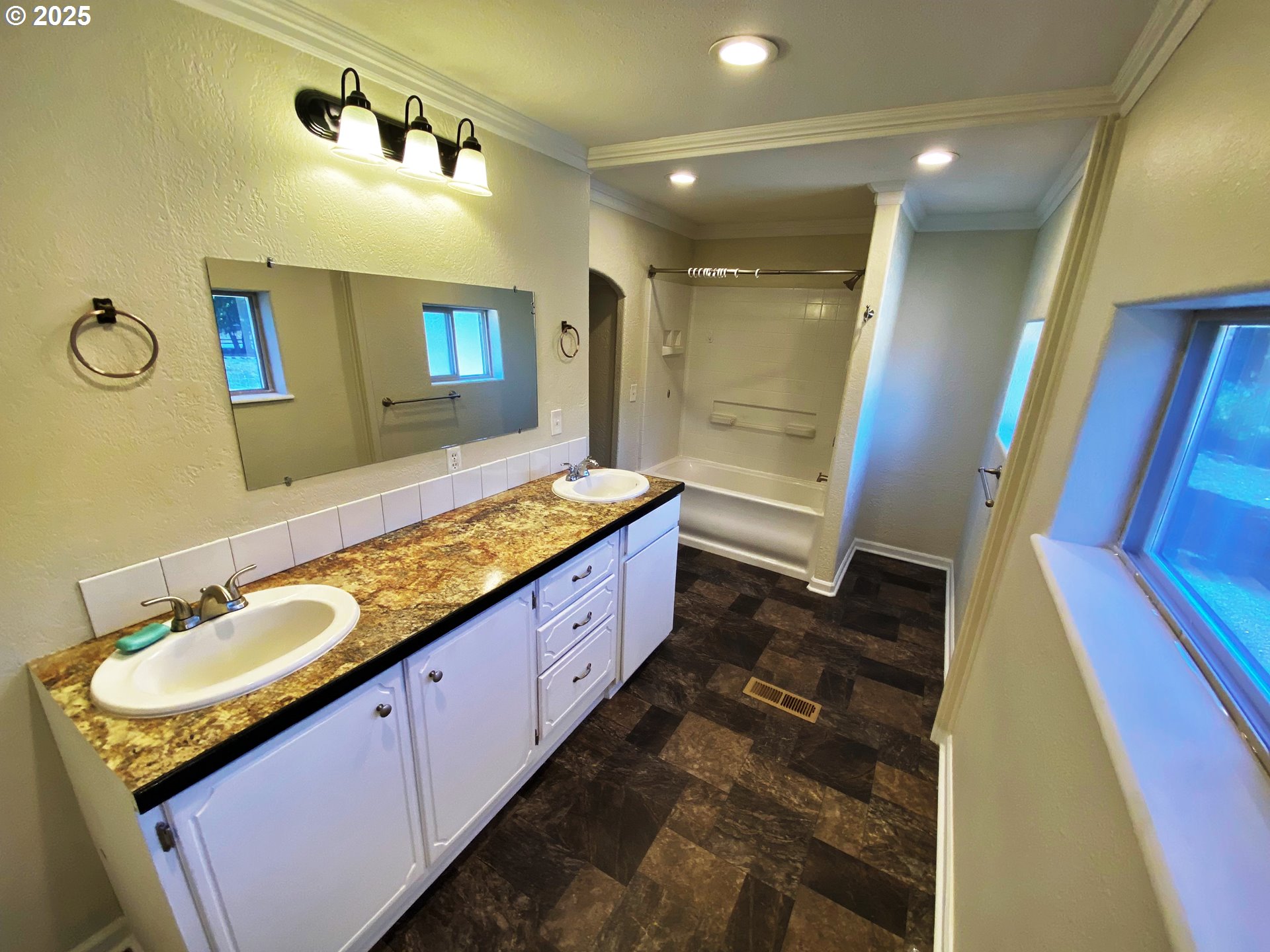 379 Mill Street Sumpter, OR 97877 - Photo 15 of 17 a large spacious bathroom with a granite countertop double vanity sink a mirror and a shower