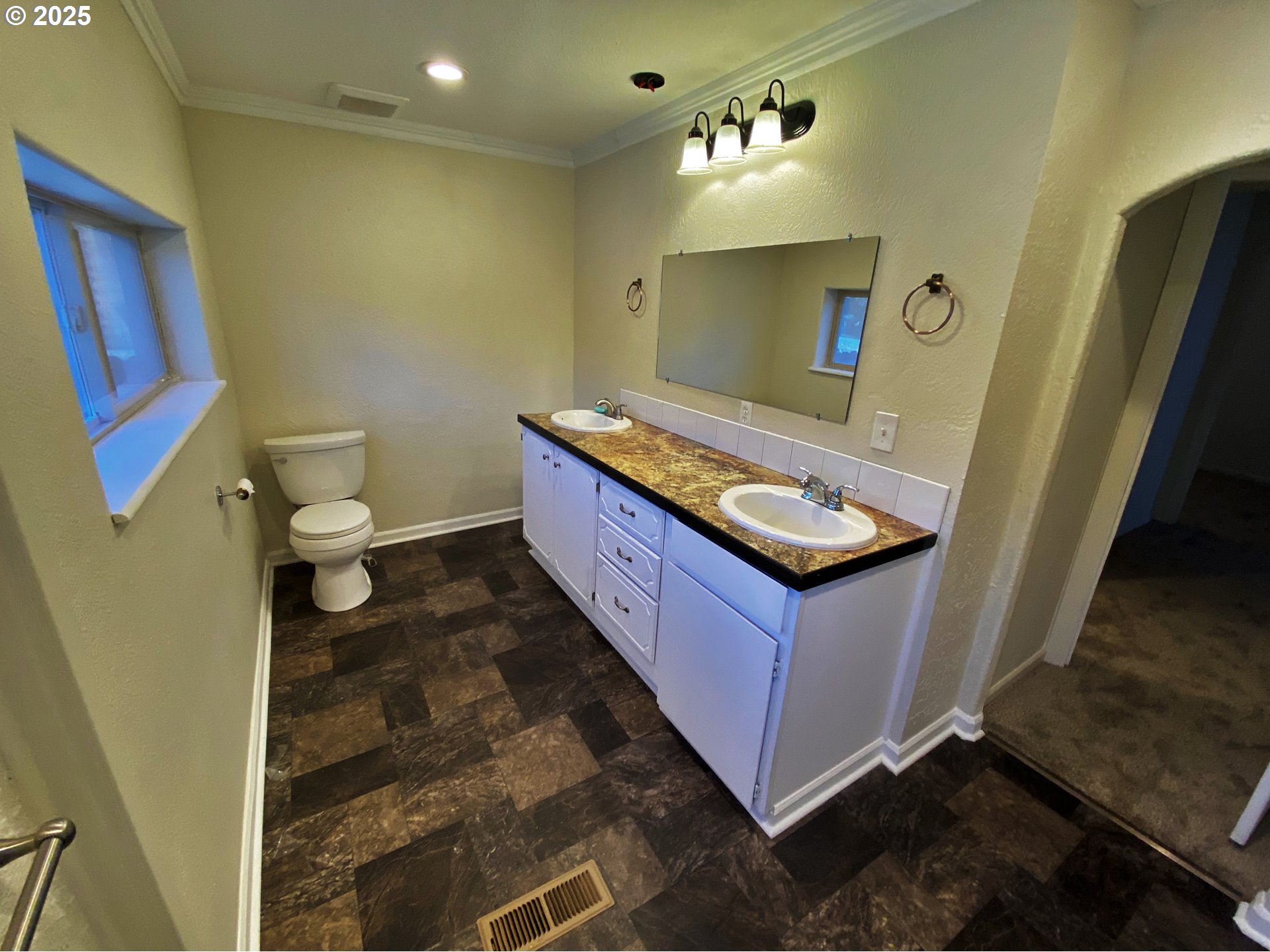 379 Mill Street Sumpter, OR 97877 - Photo 16 of 17 a bathroom with a granite countertop sink a toilet a mirror and vanity