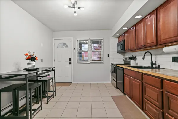 a kitchen with stainless steel appliances a stove a sink and a refrigerator