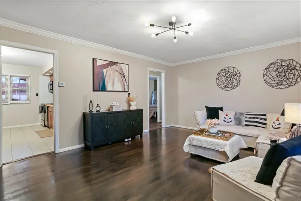 a living room with furniture and a wooden floor