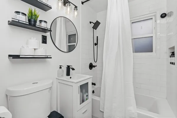 a bathroom with a sink a toilet and a mirror