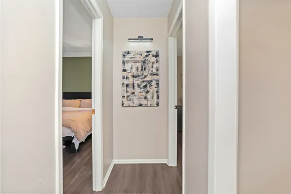 a view of a hallway with closet and bathroom