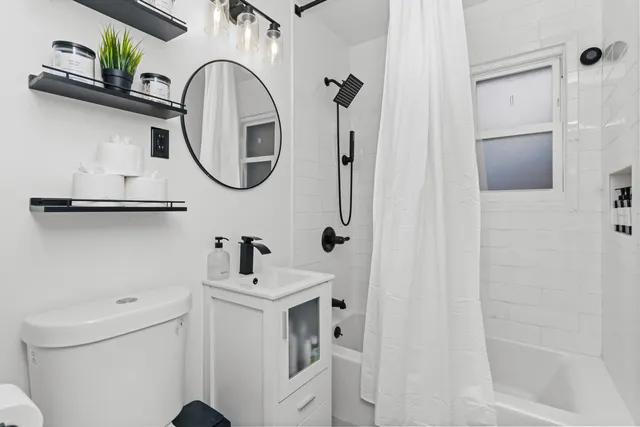 a bathroom with a sink a toilet and a mirror