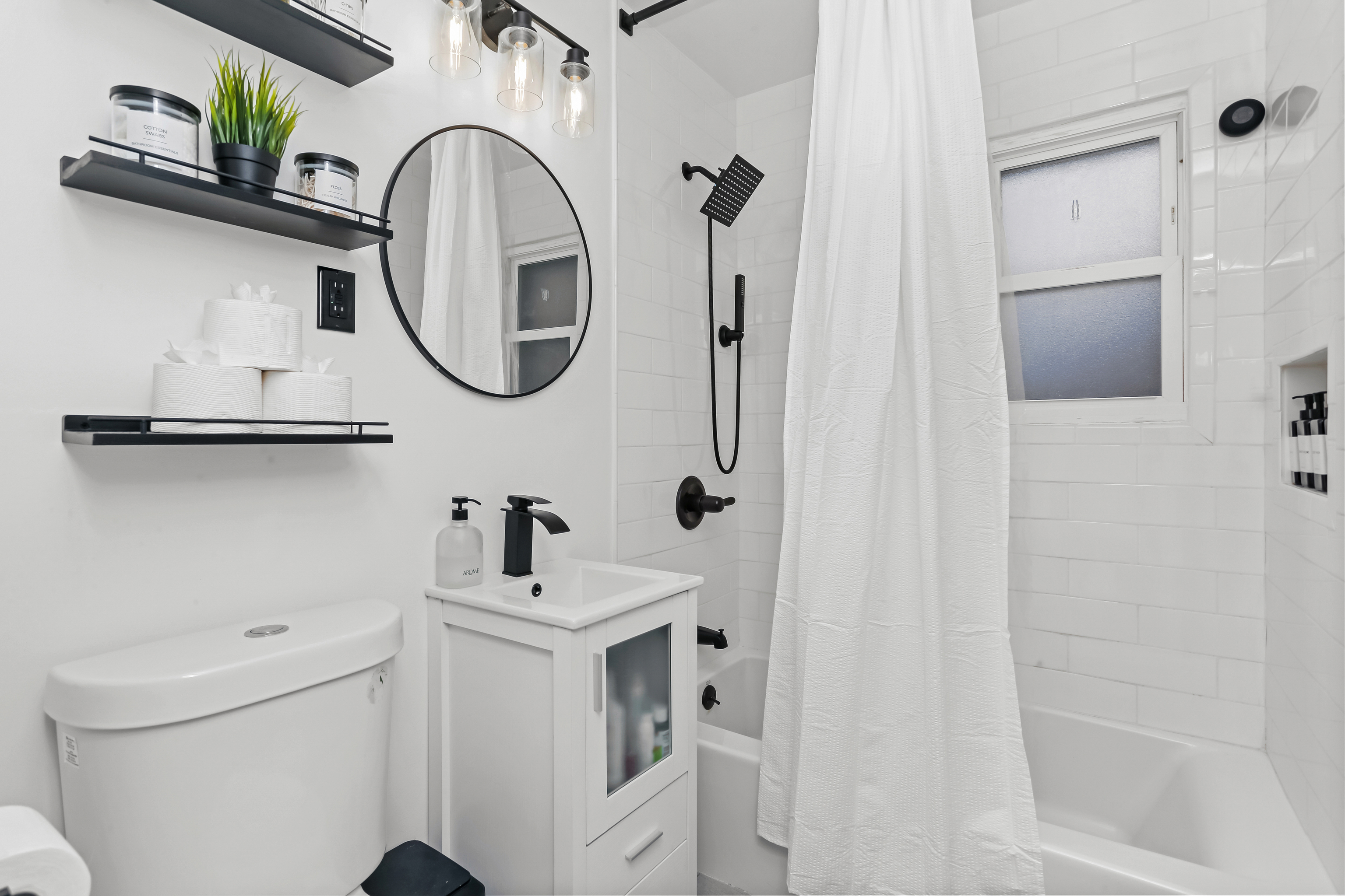 2800 Madison Avenue, Unit 1B Bridgeport, CT 06606 - Photo 7 of 10 a bathroom with a sink a toilet and a mirror