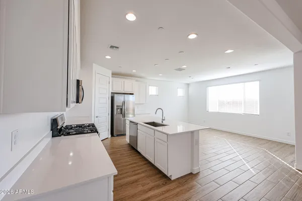 a kitchen with sink and refrigerator