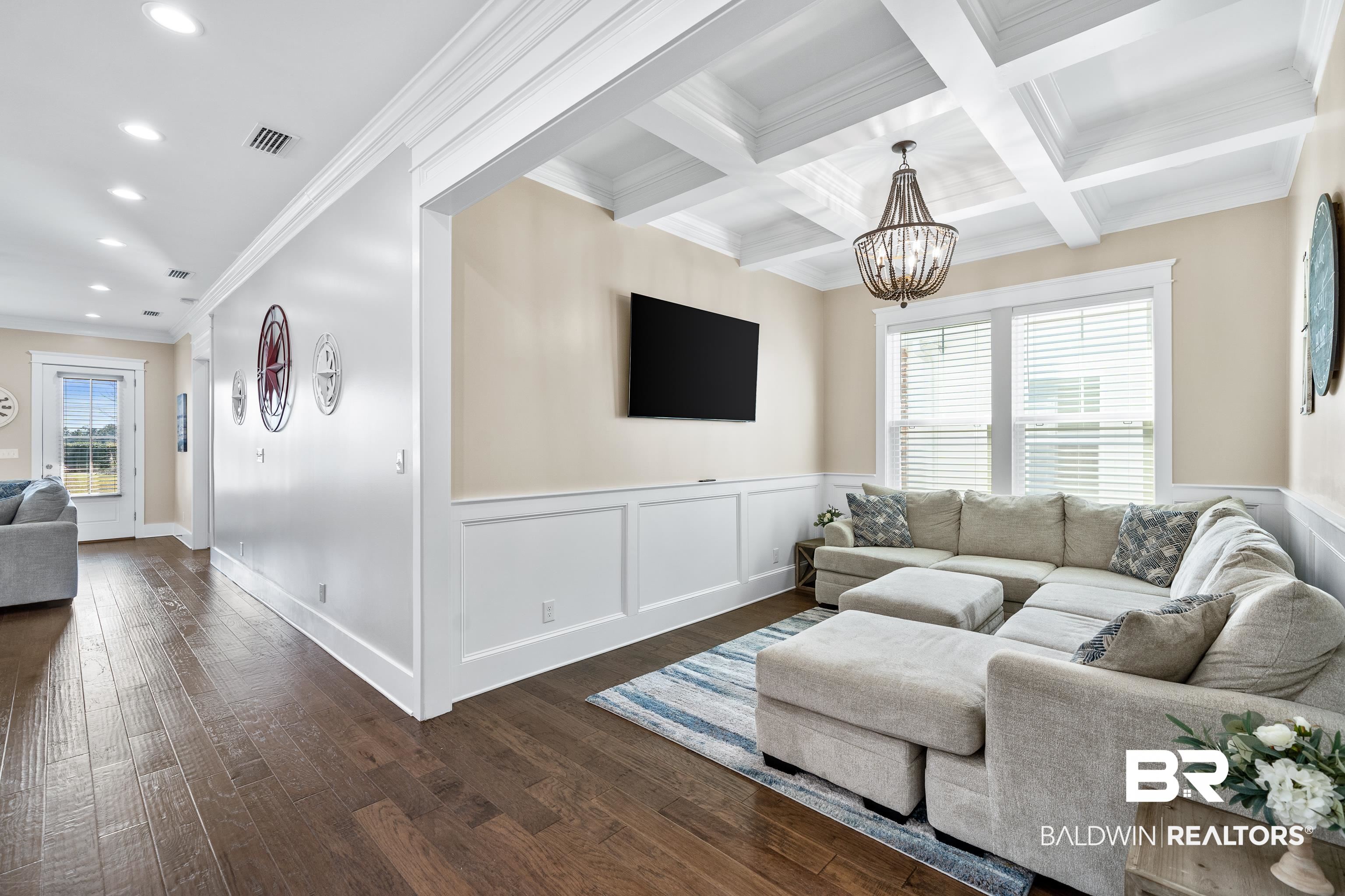 1018 Snapdragon Lane Foley, AL 36535 - Photo 19 of 37 Living room featuring beamed ceiling, an inviting chandelier, crown molding, and coffered ceiling