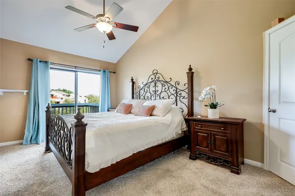 a bed sitting in a bedroom next to a window