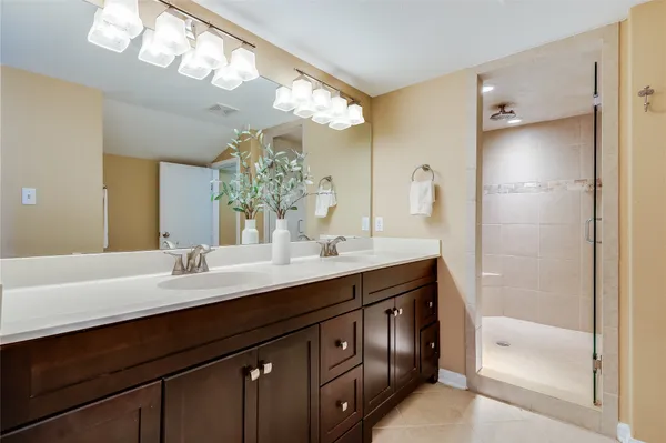a bathroom with a sink a double vanity and a mirror