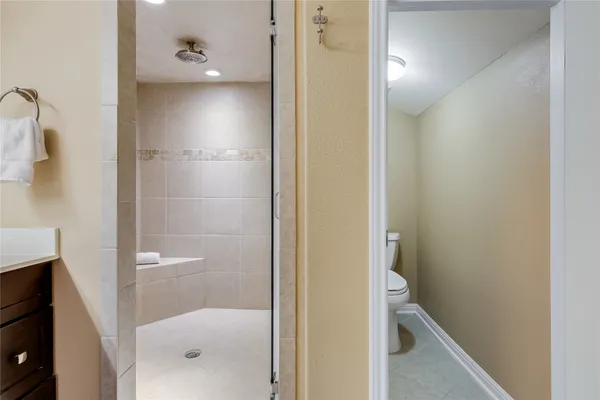 a bathroom with a glass shower door