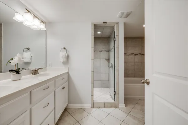 a spacious bathroom with a granite countertop sink mirror and shower
