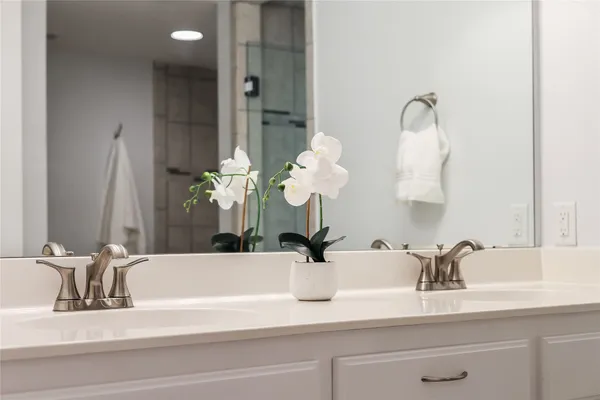 a bathroom with a sink vanity and a mirror