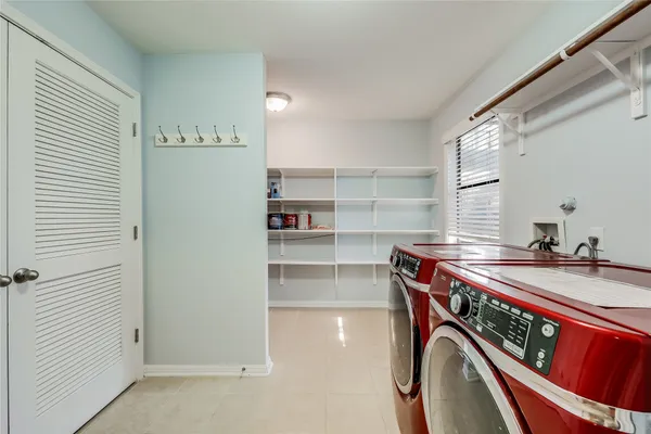 a view of a storage and utility room with washer and dryer