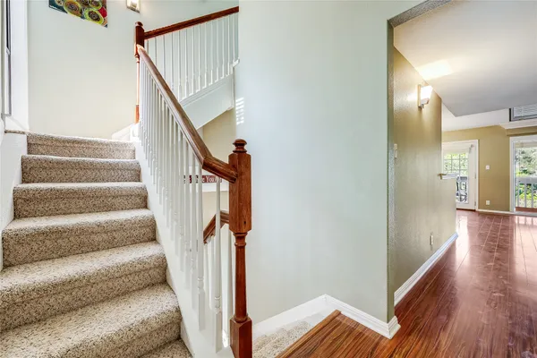 a view of staircase with wooden floor and stairs