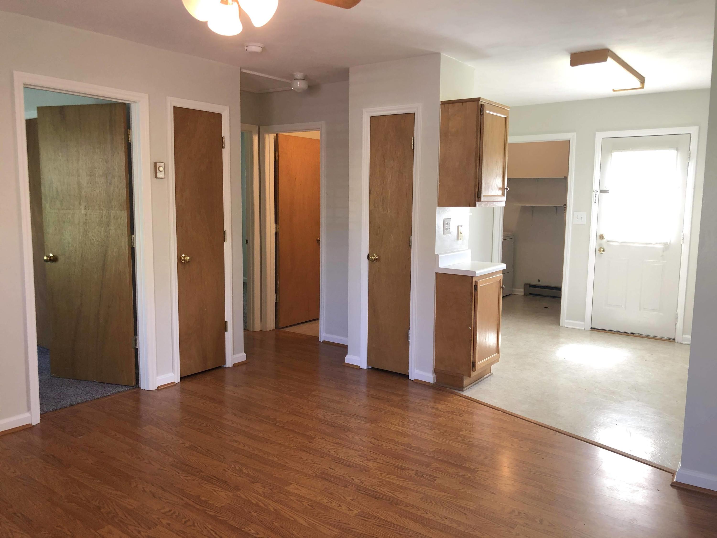 1525 Riverside Terrace Southeast Roanoke, VA 24014 - Photo 10 of 32 a view of an empty room with wooden floor and a bathroom