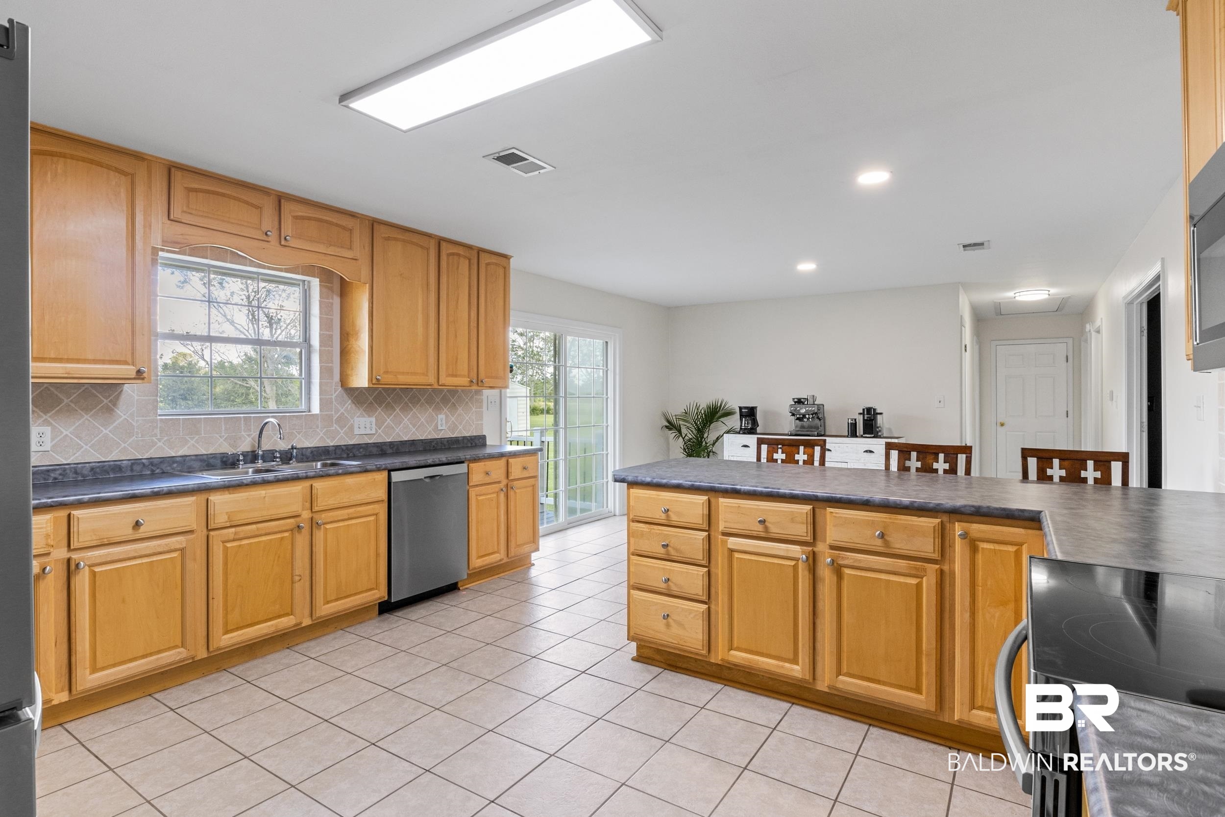 17689 Brewer Road Foley, AL 36535 - Photo 28 of 54 Kitchen featuring stainless steel appliances, backsplash, a healthy amount of sunlight, and sink
