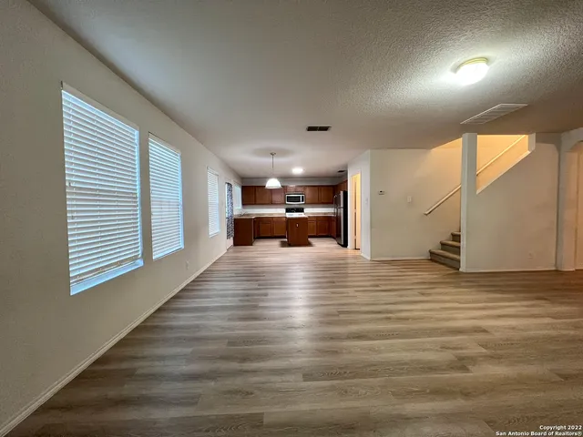 a view of kitchen and hall with wooden floor