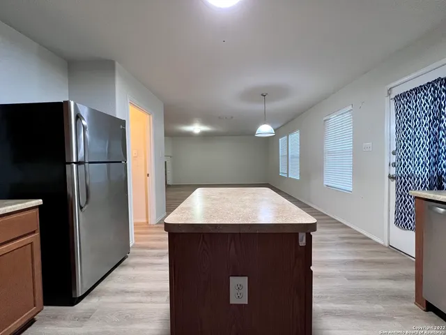 a kitchen with stainless steel appliances granite countertop a refrigerator a sink and a oven