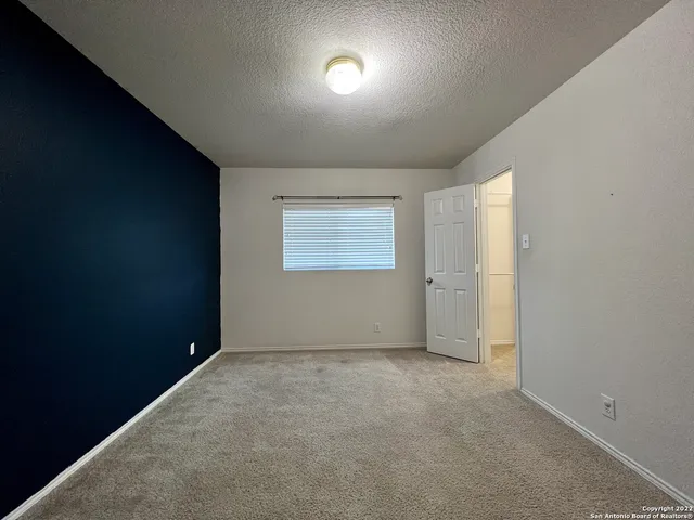 a view of an empty room and a window