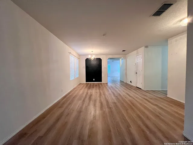 a view of a room with wooden floor