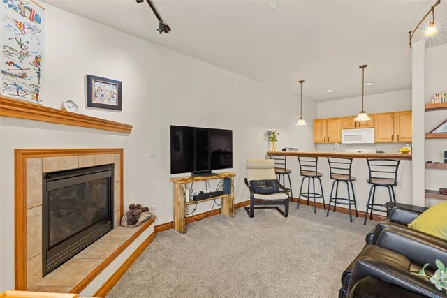 a living room with furniture flat screen tv and a fireplace