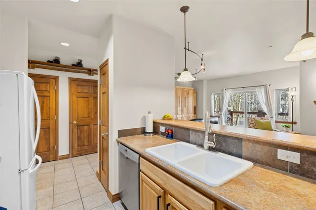 a spacious bathroom with a double vanity sink a mirror and a shower