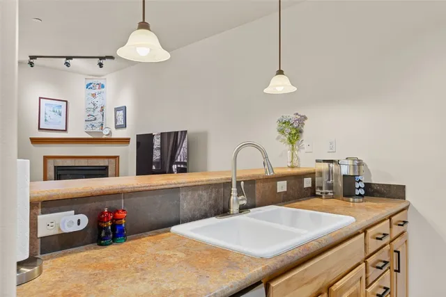 a kitchen with stainless steel appliances a table chairs and cabinets