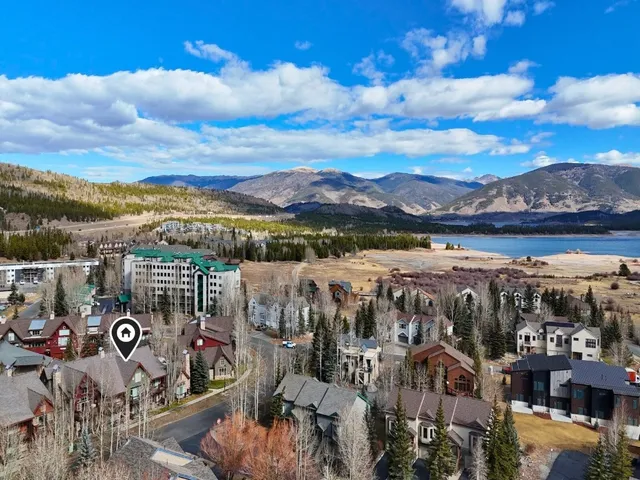 a view of a city with lots of residential buildings ocean and mountain view in back