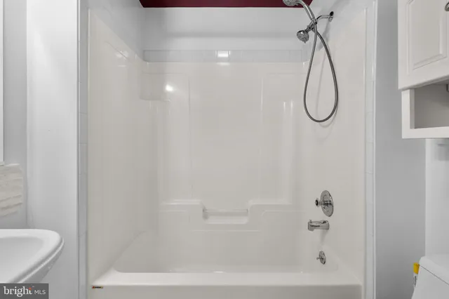 a bathroom with a bath tub with a shower