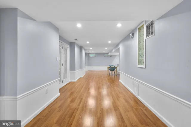 a view of a hallway with wooden floor