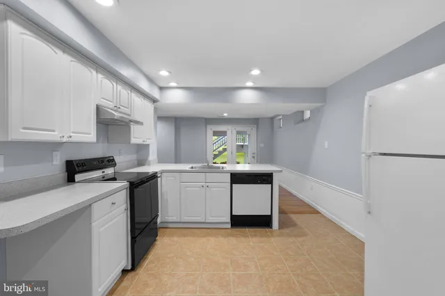 a kitchen with a sink cabinets and stainless steel appliances
