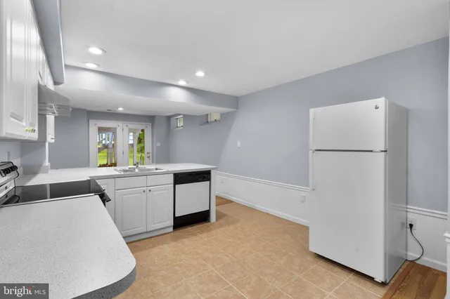 a kitchen with cabinets and white appliances