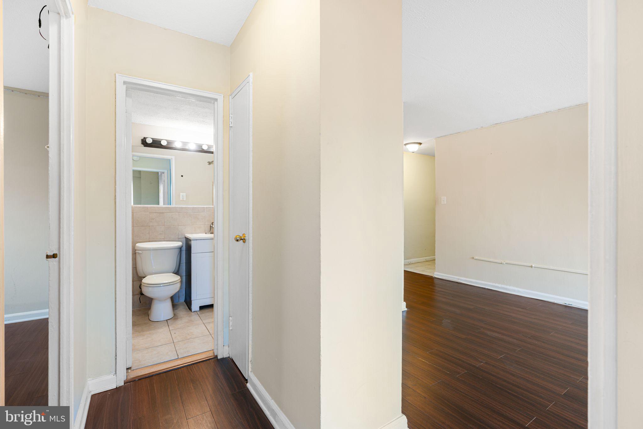 2101 Chestnut Street, Unit 518 Philadelphia, PA 19103 - Photo 12 of 14 a view of a hallway with wooden floor and a bathroom