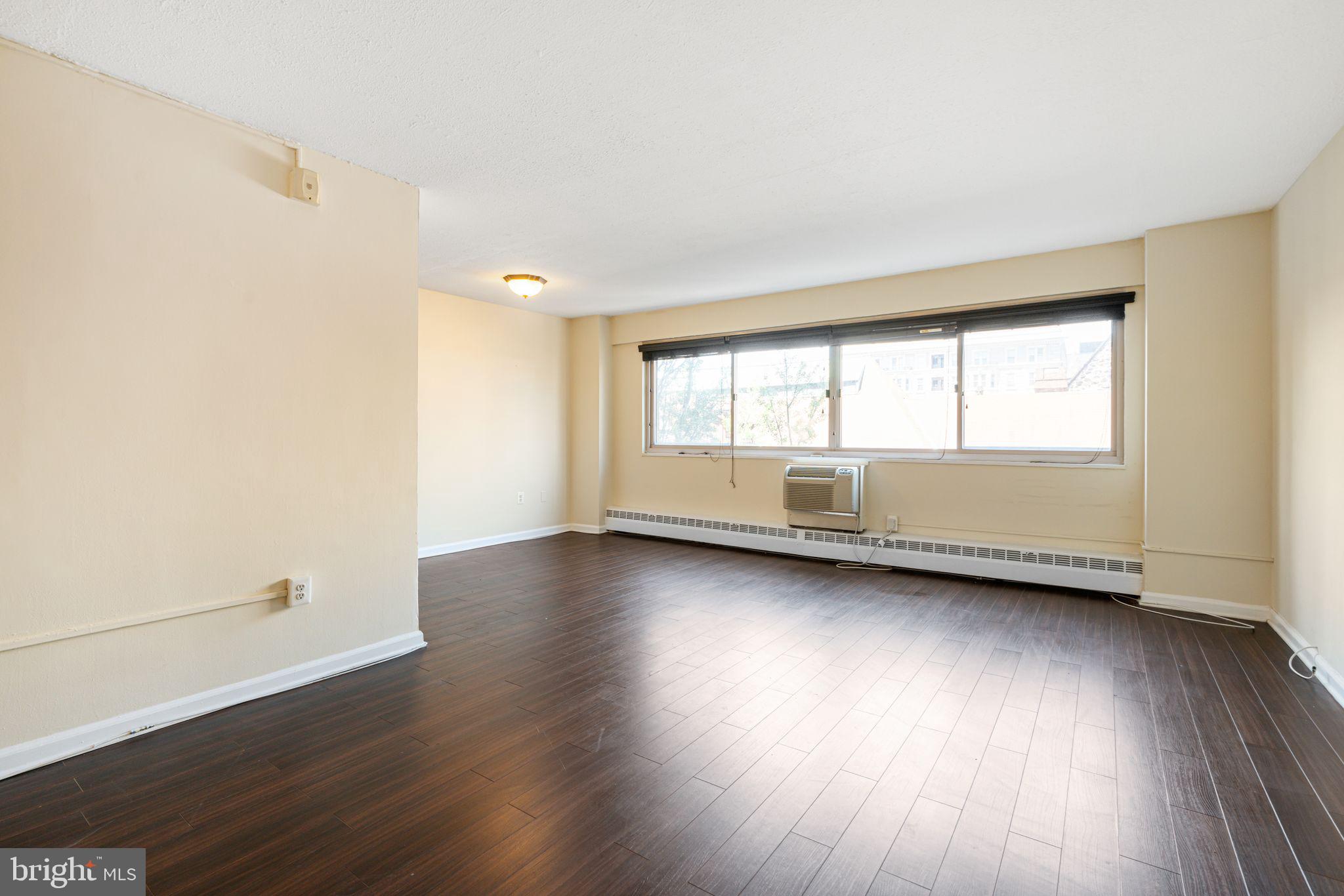 2101 Chestnut Street, Unit 518 Philadelphia, PA 19103 - Photo 3 of 14 an empty room with wooden floor and windows